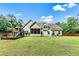 Spacious backyard with playset, screened-in porch, and ample green space, perfect for Gathering activities at 100 Chantilly Ln, Fayetteville, GA 30215
