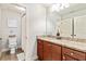 Bathroom features a granite countertop vanity, a toilet, and a shower, offering comfort and convenience at 100 Chantilly Ln, Fayetteville, GA 30215