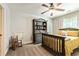 A cozy bedroom with a ceiling fan, natural lighting, and ample storage thanks to the built-in bookshelf at 100 Chantilly Ln, Fayetteville, GA 30215