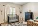 Bedroom featuring a metal crib, black dresser, and a window that allows for natural light at 100 Chantilly Ln, Fayetteville, GA 30215