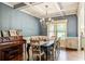 Elegant dining room with coffered ceiling, chandelier, and stylish furniture, great for entertaining at 100 Chantilly Ln, Fayetteville, GA 30215