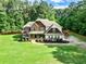 Charming two-story home featuring manicured lawn and stone accents with a welcoming front porch at 100 Chantilly Ln, Fayetteville, GA 30215