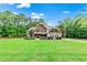 Charming two-story home with stone and shake siding, lush lawn, and mature trees in a beautiful setting at 100 Chantilly Ln, Fayetteville, GA 30215