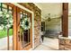 Close-up of front door with sidelights, stone accents, and cozy porch swing at 100 Chantilly Ln, Fayetteville, GA 30215