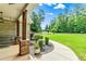 Covered front porch with stone columns, swing, and beautifully landscaped front yard at 100 Chantilly Ln, Fayetteville, GA 30215