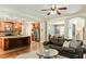 Open-concept kitchen and living area with a central island, stainless steel appliances, and hardwood flooring at 100 Chantilly Ln, Fayetteville, GA 30215