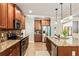 Bright kitchen featuring granite countertops, modern appliances, and seamless access to other living spaces at 100 Chantilly Ln, Fayetteville, GA 30215