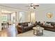 Spacious living area featuring hardwood flooring, crown molding, and seamless flow to the dining room at 100 Chantilly Ln, Fayetteville, GA 30215