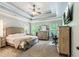 Spacious main bedroom with tray ceiling, carpeting, TV, three windows, and neutral color palette at 100 Chantilly Ln, Fayetteville, GA 30215