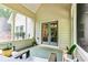 Covered porch with neutral tones, screened windows, and comfortable seating area, perfect for relaxing outdoors at 100 Chantilly Ln, Fayetteville, GA 30215