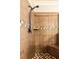 Detailed view of the tiled shower featuring a built-in bench, shower head, and mosaic tile accent at 100 Chantilly Ln, Fayetteville, GA 30215