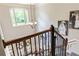 Elegant staircase featuring wood railing, iron spindles, and ample natural light from the large arched window at 100 Chantilly Ln, Fayetteville, GA 30215