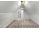 Attic area features neutral carpet, white walls, sloped ceilings and a closet at 1571 Boulevard Lorraine Sw, Atlanta, GA 30311