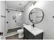Modern bathroom featuring white subway tile shower and dark vanity at 1571 Boulevard Lorraine Sw, Atlanta, GA 30311