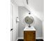 Bathroom featuring a wooden vanity, round mirror, and decorative accents at 1571 Boulevard Lorraine Sw, Atlanta, GA 30311