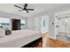 Primary bedroom featuring hardwood floors, ensuite bath and closet with natural light at 1571 Boulevard Lorraine Sw, Atlanta, GA 30311