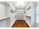 Large walk-in closet with custom shelving and hardwood floors at 1571 Boulevard Lorraine Sw, Atlanta, GA 30311