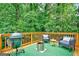 Outdoor deck with grill, seating, and view of surrounding trees at 1571 Boulevard Lorraine Sw, Atlanta, GA 30311