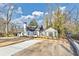 Attractive home featuring a gray roof, white and gray paint, a chimney, and a manicured lawn at 1571 Boulevard Lorraine Sw, Atlanta, GA 30311
