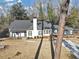 Beautiful home featuring a gray roof, white and gray paint, a chimney, and a manicured lawn at 1571 Boulevard Lorraine Sw, Atlanta, GA 30311