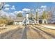 Charming home boasts a well-manicured front lawn, white paint, black trim, and a chimney at 1571 Boulevard Lorraine Sw, Atlanta, GA 30311