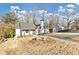 Charming home boasts a well-manicured front lawn, white paint, black trim, and a chimney at 1571 Boulevard Lorraine Sw, Atlanta, GA 30311