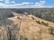 Aerial view of a golf course with dormant grass, bare trees and a black golf cart path at 1571 Boulevard Lorraine Sw, Atlanta, GA 30311