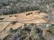 Aerial view of a golf course with dormant grass, bare trees and a black golf cart path at 1571 Boulevard Lorraine Sw, Atlanta, GA 30311