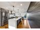 Modern kitchen featuring an island, stainless steel appliances, and two pendant lights at 1571 Boulevard Lorraine Sw, Atlanta, GA 30311