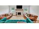 Spacious living room area featuring a brick fireplace, hardwood floors, and plenty of seating at 1571 Boulevard Lorraine Sw, Atlanta, GA 30311