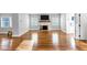 Spacious living room with hardwood floors, a brick fireplace, and neutral paint colors at 1571 Boulevard Lorraine Sw, Atlanta, GA 30311