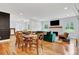 Open-concept living and dining area featuring hardwood floors and a fireplace at 1571 Boulevard Lorraine Sw, Atlanta, GA 30311