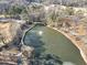 Aerial view of a pond with a fountain, dock, and bare trees at 1571 Boulevard Lorraine Sw, Atlanta, GA 30311