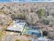 Aerial view of a community clubhouse with pool and tennis courts surrounded by trees at 1571 Boulevard Lorraine Sw, Atlanta, GA 30311