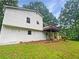 Back exterior featuring a wood deck, grass and white siding at 2325 Sebring Sw Ct, Marietta, GA 30064