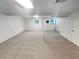 Spacious finished basement with carpet and natural light from a window and door at 2325 Sebring Sw Ct, Marietta, GA 30064