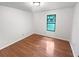 A bedroom featuring light hardwood floors, white walls, and a window looking out into the lawn at 2325 Sebring Sw Ct, Marietta, GA 30064