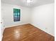 A cozy bedroom featuring hardwood floors, a light-filled window, and neutral walls at 2325 Sebring Sw Ct, Marietta, GA 30064