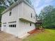 View of the house exterior featuring a 2-car garage and a small deck area at 2325 Sebring Sw Ct, Marietta, GA 30064