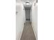 A carpeted hallway with white walls, showcasing multiple doors leading to various rooms in the home at 2325 Sebring Sw Ct, Marietta, GA 30064