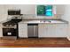 The kitchen boasts white cabinets, stainless steel appliances, and durable hardwood floors at 2325 Sebring Sw Ct, Marietta, GA 30064