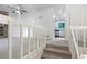 A living room area as seen from the top of the stairs, showcasing open floor plan and large windows at 2325 Sebring Sw Ct, Marietta, GA 30064