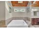 Bright bathroom with a skylight, stained glass window, and a large soaking tub at 2505 Oakrill Rd, Marietta, GA 30062