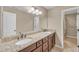Bathroom featuring a dual sink with granite countertop and dark cabinetry at 2505 Oakrill Rd, Marietta, GA 30062