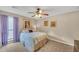 Comfortable bedroom featuring a ceiling fan, plush carpeting, and plenty of sunlight at 2505 Oakrill Rd, Marietta, GA 30062