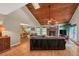 Open-concept living room with hardwood floors, a stone fireplace, and a wood ceiling at 2505 Oakrill Rd, Marietta, GA 30062