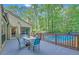Outdoor patio with blue table and chairs overlooking a refreshing pool, perfect for relaxation at 2505 Oakrill Rd, Marietta, GA 30062