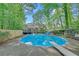 Sparkling pool surrounded by lush greenery, with a diving board and lounge chairs at 2505 Oakrill Rd, Marietta, GA 30062