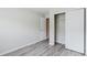 A bright bedroom offers new light wood flooring, closet, and an entry door at 3453 Dianthus Ln, Lawrenceville, GA 30044