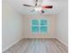 This bedroom offers natural light from the window and a modern ceiling fan at 3453 Dianthus Ln, Lawrenceville, GA 30044